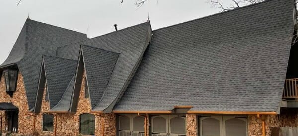 Steep angled asphalt shingle roof on large estate